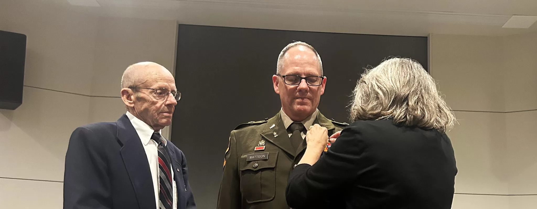 Command Chief Warrant Officer Charles Mattison has chief warrant officer 5 rank pinned on by his father Michael and wife Kathy during a July 12 promotion ceremony at Joint Force Headquarters’ Witmer Hall in Madison, Wis. Wisconsin National Guard photo by Staff Sgt. Alice Ripberger