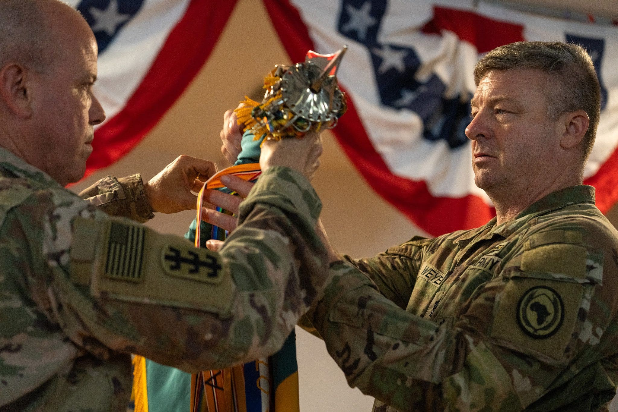 Col. Eric Leckel and Command Sgt. Maj. Duane Weyer, commander and senior enlisted leader for the Wisconsin Army National Guard’s 157th Maneuver Enhancement Brigade, case their brigade colors during a Transfer of Authority ceremony at Camp Lemonnier, Djibouti, July 14. Unit colors traditionally serve to signal the presence of that unit in a field or garrison environment — the ceremony signifies the pending departure of one unit and the emplacement of the other. Department of Defense photo by U.S. Air Force Staff Sgt. Dylan Gentile 