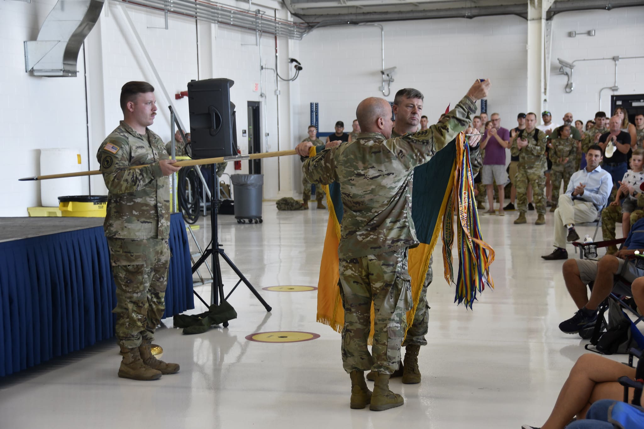 Col. Eric Leckel and Command Sgt. Maj. Duane Weier, commander and senior enlisted leader of the Wisconsin Army National Guard’s 157th Maneuver Enhancement Brigade, uncase the brigade flag, signifying the unit’s return to the Wisconsin National Guard, during a welcome home ceremony July 29 at the 115th Fighter Wing in Madison, Wis. The 157th returned from a nine-month deployment to Djibouti, Africa in support of Combined Joint Task Force-Horn of Africa, which conducts operations to enhance partner nation capacity, promote regional stability, dissuade conflict, and protect U.S. and coalition interests. Wisconsin Department of Military Affairs photo by Vaughn R. Larson