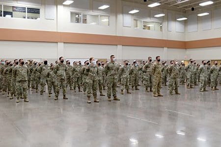 Joint Task Force 64 members stand in formation during a ceremony Aug. 24 at the Armed Forces Reserve Center in Madison, Wis., honoring Wisconsin National Guard troops who have supported the state's COVID-19 response efforts since March 2020. Wisconsin Gov. Tony Evers proclaimed Aug. 24, 2021, as Wisconsin National Guard COVID-19 Support Recognition Day, thanking Wisconsin National Guard members for their continued efforts in the state's COVID-19 response efforts. Wisconsin Department of Military Affairs photo by Kelly Bradley