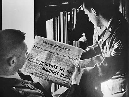 32nd Infantry Division Soldiers read news of their deployment as they travel to Fort Lewis, Wash., in October 1961. 32nd Infantry Division STRAC Yearbook, 1961-1962