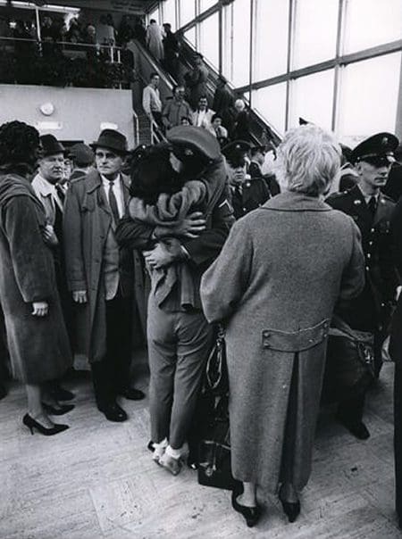 A departing member of the Wisconsin National Guard shares an embrace and a last kiss as he and other members of his unit prepared to fly out of General Mitchell Field for Fort Lewis, Wash., on Oct. 20, 1961. Milwaukee Journal photo