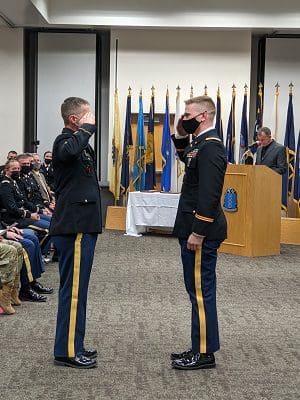  Sgt. Eric Linn (left) renders a first salute to 2nd Lt. Joseph Linn (right) after pinning him with his second lieutenant rank during an Oct. 16 ceremony at the Wisconsin Military Academy at Fort McCoy, Wis. The 426th Regiment (Regional Training Institute) commissioned 12 new officers and six new warrant officers to the ranks of the Wisconsin National Guard during the ceremony. Submitted photo